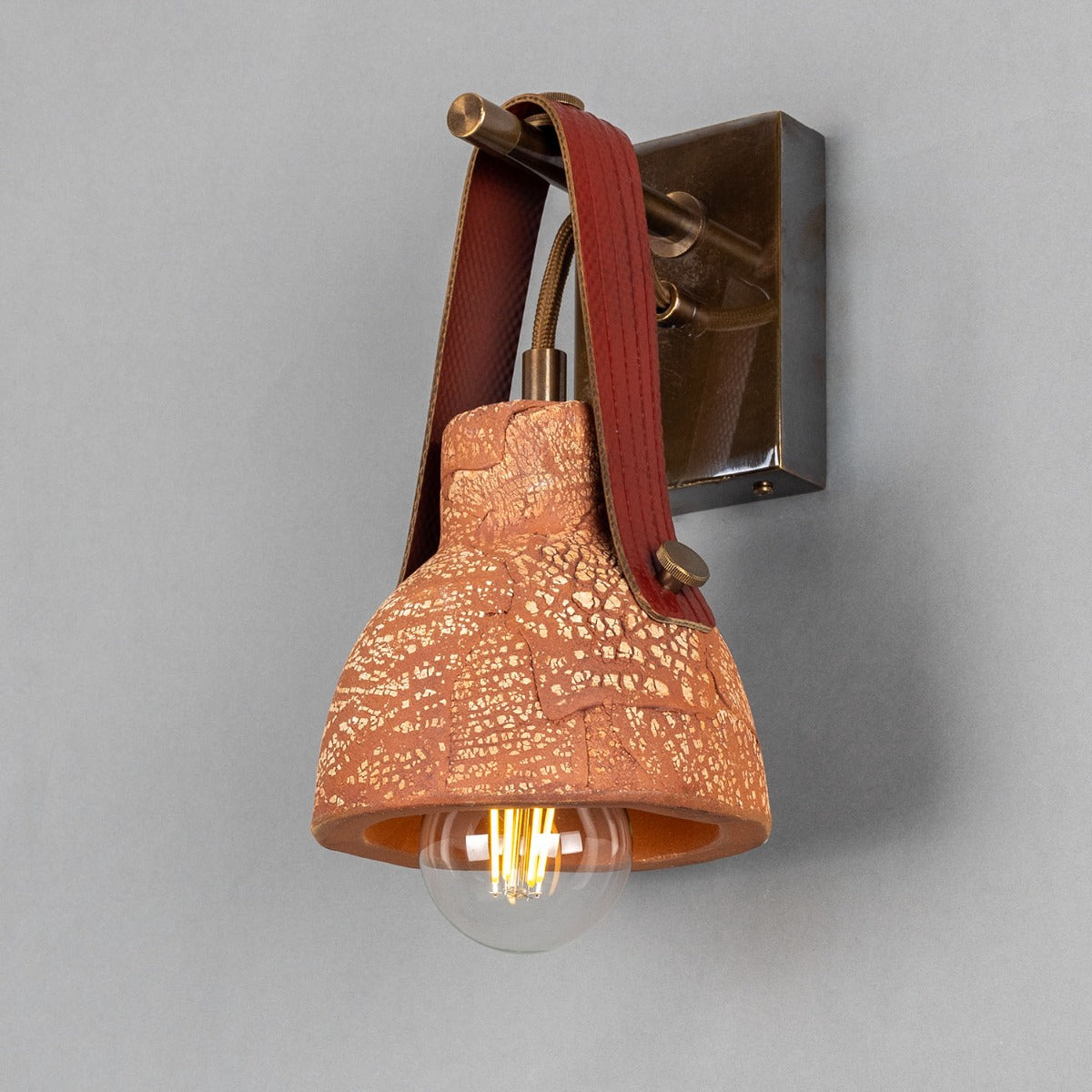 Nagi Organic Ceramic Wall Light with Rescued Fire-Hose Strap, Red Iron - Main View